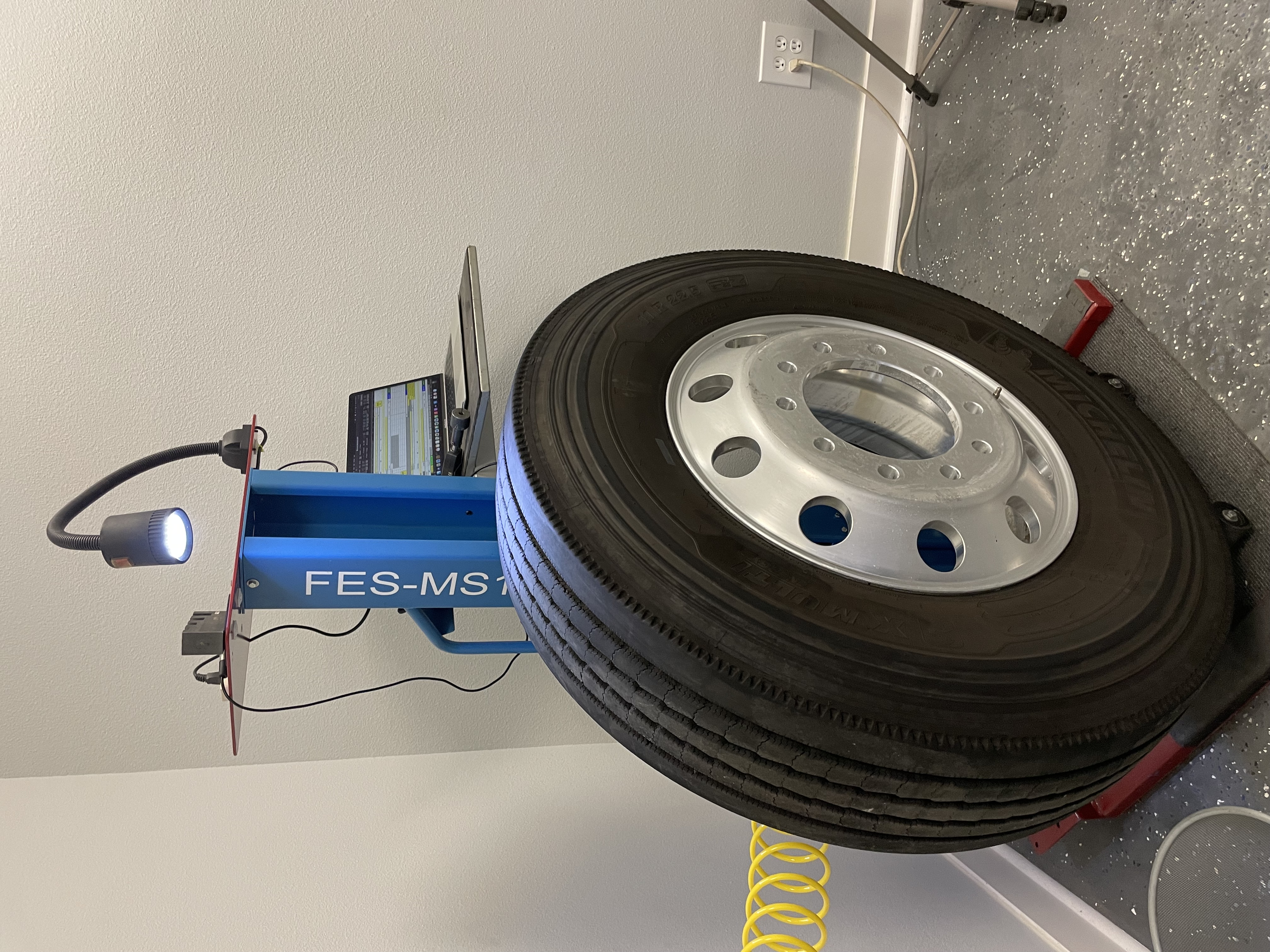 Custom tire measurement stand supporting repeatable inspection procedures